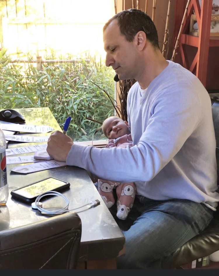 Scott Connors writing at his desk